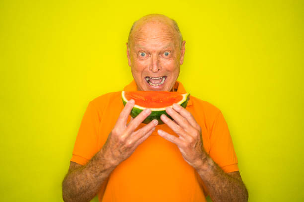 istock happy senior man biting from water melon 1127492676