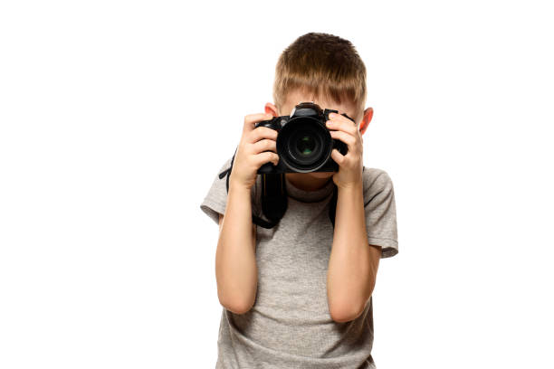 istock Boy takes pictures on the camera. Portrait. Isolate on white background 1127492755