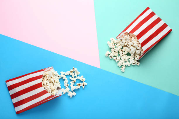 istock Popcorn in paper bags on colorful background 1127493598