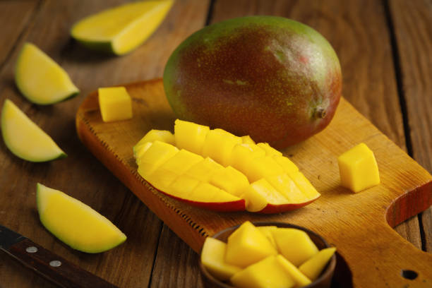 istock Fresh juicy mango slice on a wooden table 1127494004