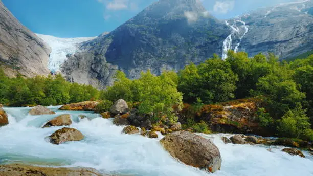 Photo of The incredible nature of Norway is a turbulent river from the melted waters of the Briksdal Glacier