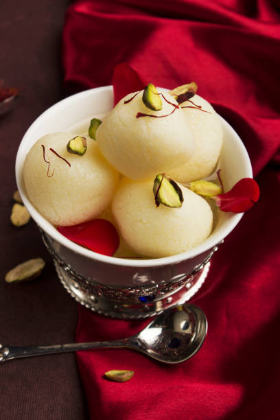 A bowl full with typical Indian sweet rasgulla, Pune, India A bowl full with typical Indian sweet rasgulla, Pune, India rosogolla stock pictures, royalty-free photos & images