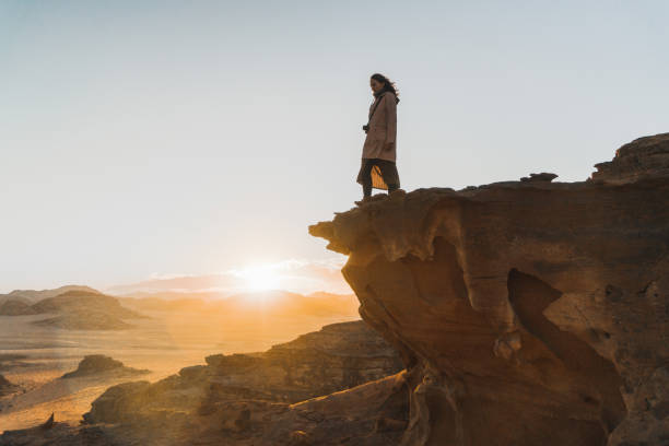 istock Woman looking at  Wadi Rum desert from rock 1127497731