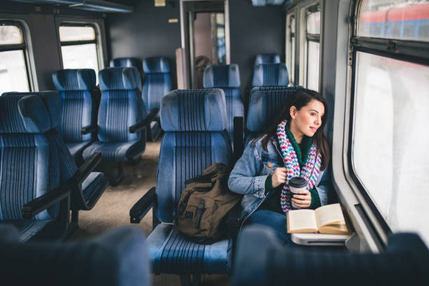 istock Young beautiful woman looking through the train window. 1127497791
