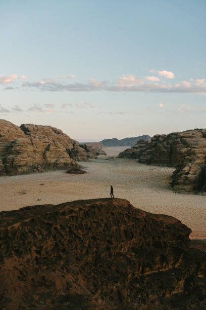 istock Man looking at  Wadi Rum desert from rock 1127498835