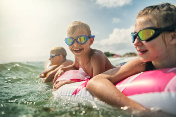 istock Kids having fun in sea on air bed 1127500648