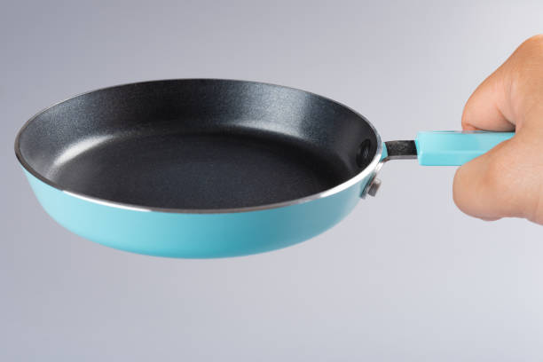 istock man holding a small metal pan 1127500957