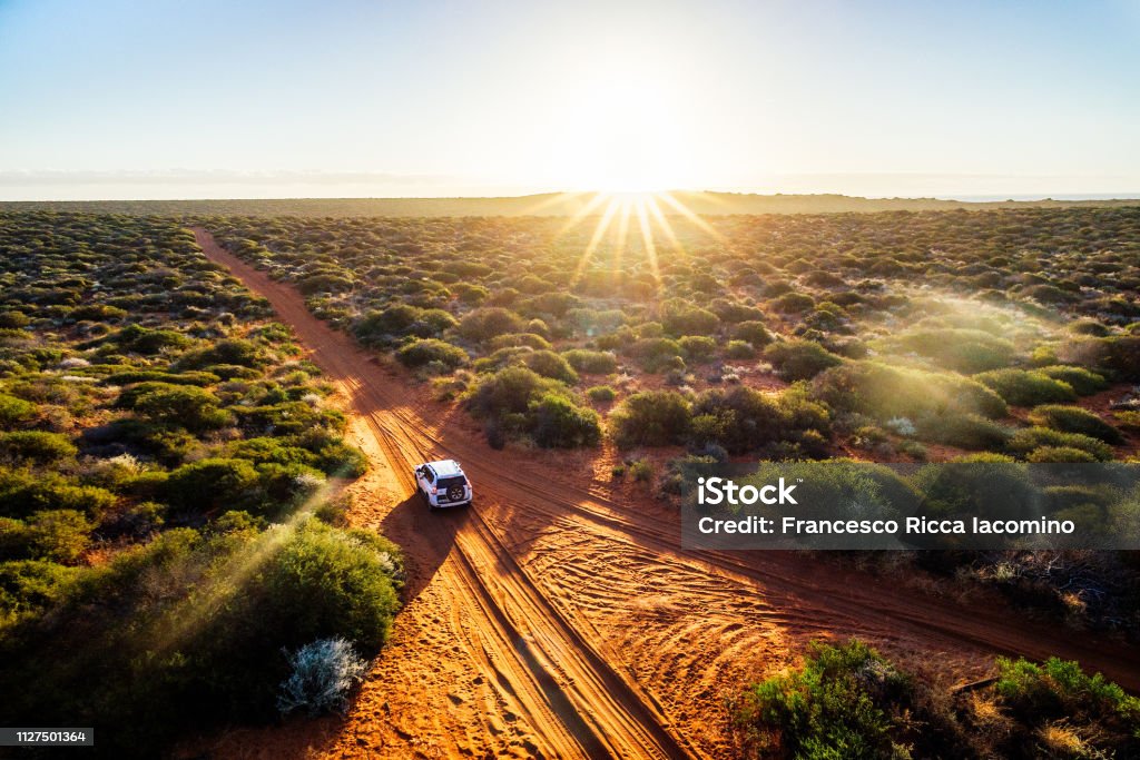 Driving off-road in Western Australia at sunset Driving off-road in Western Australia at sunset, aerial view. Francois Peron National Park Australia Stock Photo