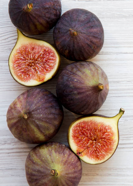istock Fresh figs on white wooden table, overhead view. From above, flat lay. Close-up. 1127502515