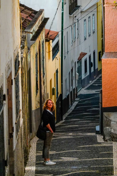 Paul Do Mar, Madeira, Portugal A woman tourist walking along an old street.