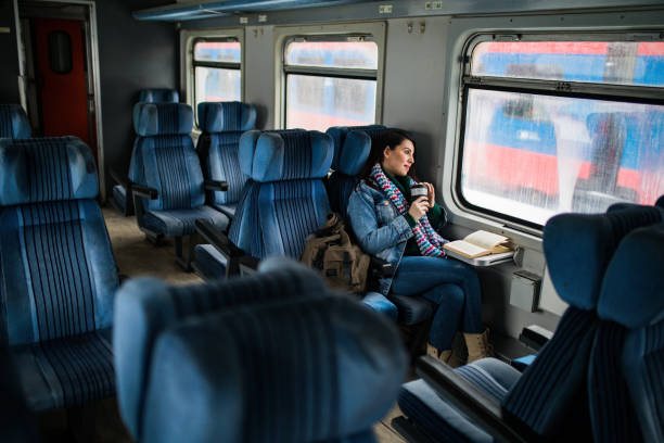 istock Young beautiful woman looking through the train window. 1127503255