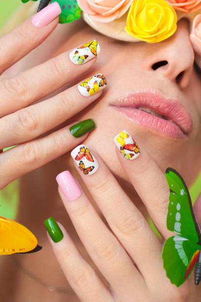 istock Multi-colored manicure on nails with a design of butterflies. 1127503533