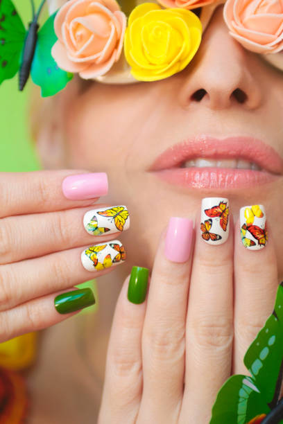 istock Multi-colored manicure on nails with a design of butterflies. 1127503544