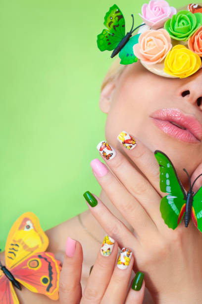istock Multi-colored manicure on nails with a design of butterflies. 1127503553