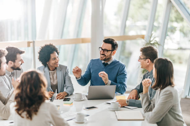 istock Happy business team talking on a meeting at conference table. 1127504698