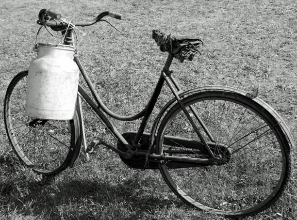 istock bicycle with a broken saddle and the milk can 1127504710