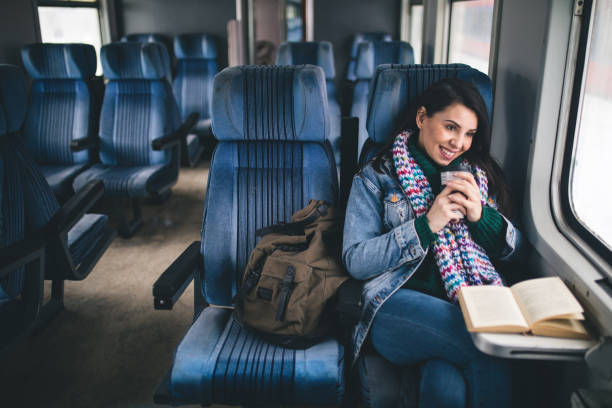istock Young beautiful woman looking through the train window. 1127505433