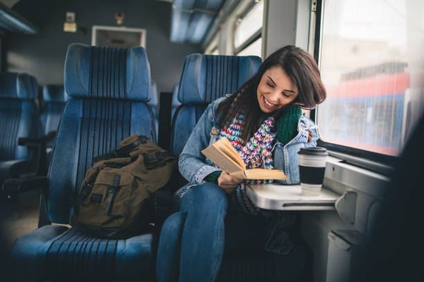 Women reading book on the train stock photo
