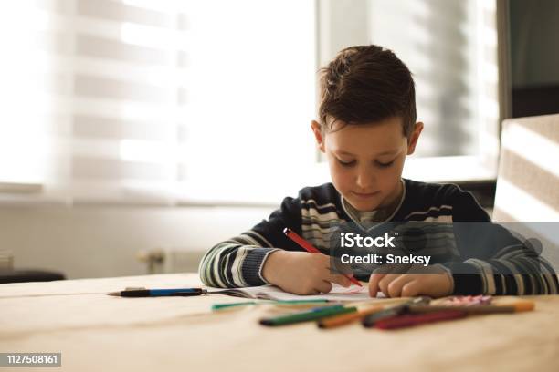 Junge Zu Hause Machen Hausaufgaben Schreiben Von Briefen Mit Bunten Stiften Stockfoto und mehr Bilder von Akademisches Lernen