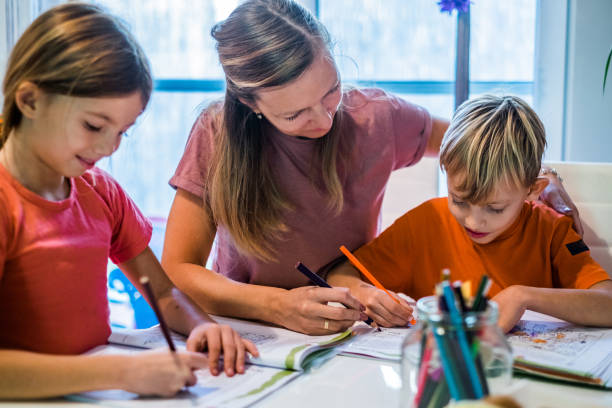 istock Mother helping her son to do homework 1127509019