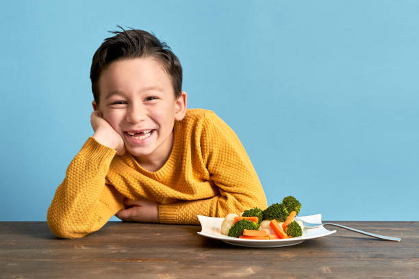 istock Child is eating vegetables. 1127509319