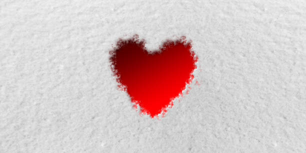 istock Red Heart in front of Snow Background 1127509756