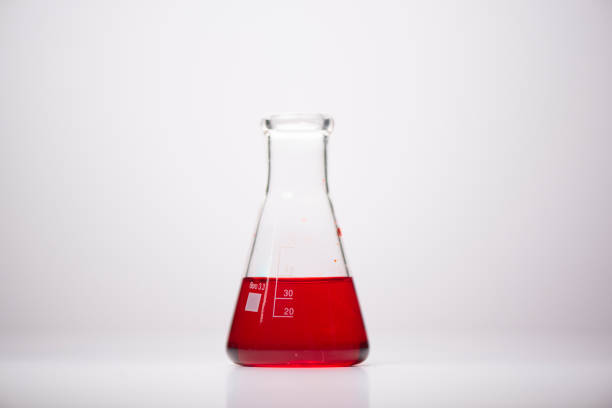 empty glass medicine bottle on red background