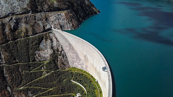 Top aerial view of Kolnbrein Dam and Malta road on Kolnbreinspeicher lake in Carinthia, Austria.