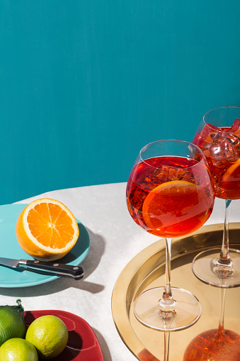 Spritz veneziano, an IBA cocktail with Prosecco or white sparkling wine, bitter, soda, ice and a slice of orange, in a calix on a table, pop graphic style