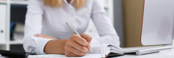 istock Beautiful female student hold the pen in his hand 1127512038
