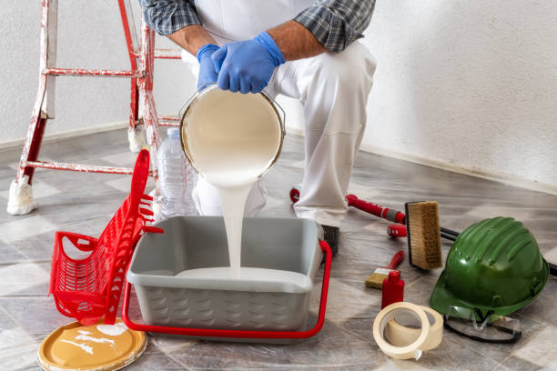 istock Professional house painter at work prepares the wall paint 1127513299
