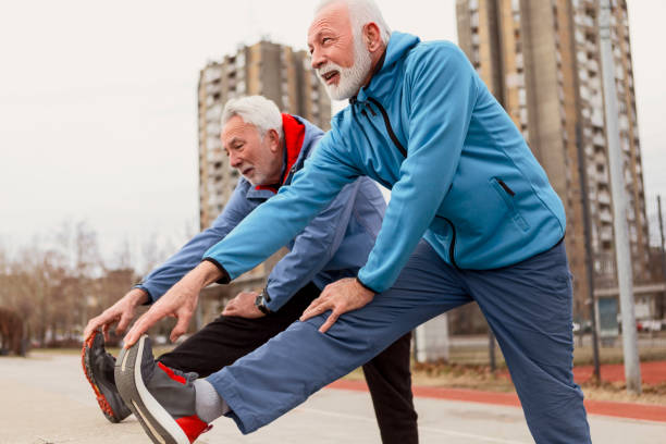 istock Two senior sportsman warming up 1127517359