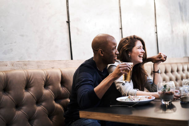 istock Happy young couple sitting at restaurant table 1127517481