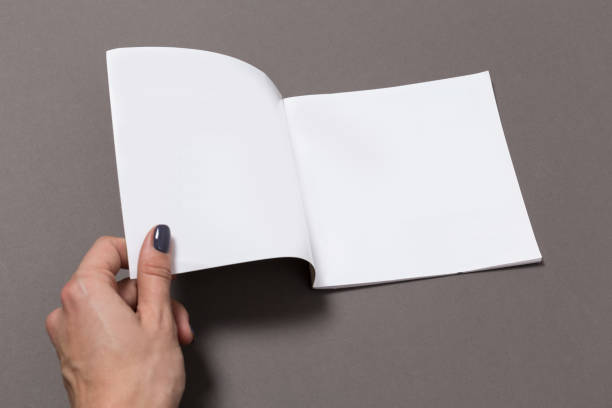 istock Blank Notebook Mock-up with hand on cover, redy to replace your design. 1127517611