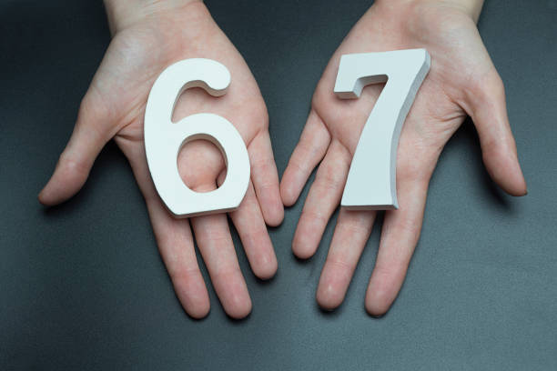 istock To female hands the number sixty-seven. 1127517755