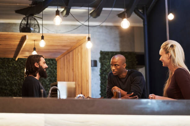 istock Multi-ethnic young friends talking in restaurant 1127518030