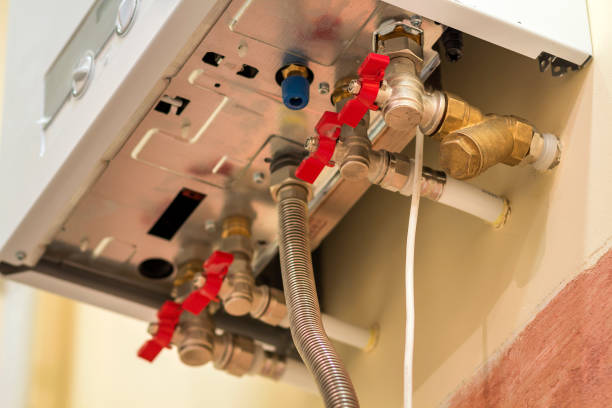 istock Gas water heater boiler for home heating, bottom view. Installation, connection and maintenance concept. 1127519367