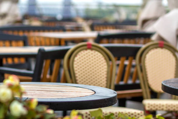 istock Outdoors empty cafe with nobody, restaurant round plastic coffee tables and comfortable chairs on summer sunny urban sidewalk. Food and recreation. 1127519421