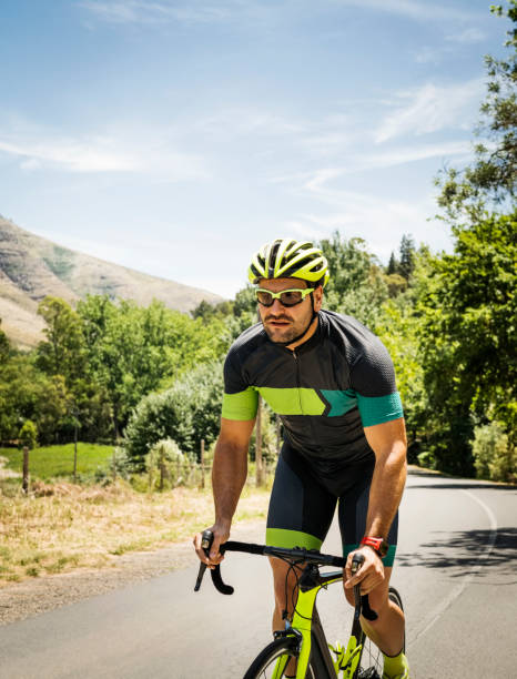 istock Determined male cyclist riding bicycle on road 1127519658