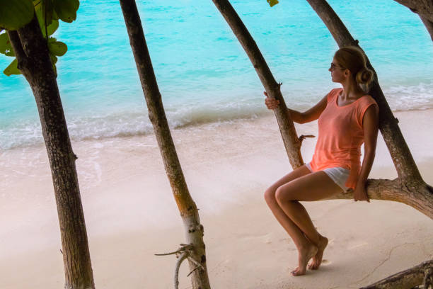 istock Beautiful woman resting by the sea 1127520384
