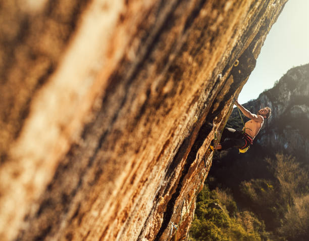 istock Young man sport climbing in overhanging position 1127520417
