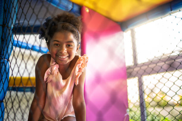 Afro latinx girl playing at playground portrait Childhood afro latinx ethnicity stock pictures, royalty-free photos & images