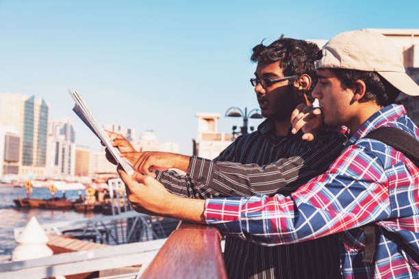 istock Friends visiting Dubai, looking for tourist attractions on the map 1127522847
