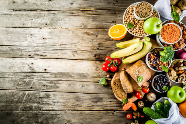 Good carbohydrate fiber rich food Healthy food. Selection of good carbohydrate sources, high fiber rich food. Low glycemic index diet. Fresh vegetables, fruits, cereals, legumes, nuts, greens. Wooden background copy space dietary fiber photos stock pictures, royalty-free photos & images