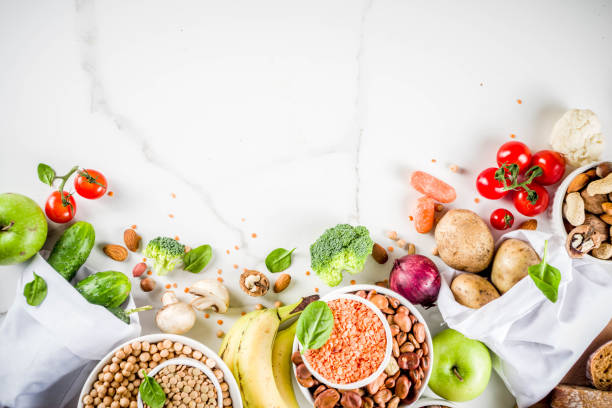 Good carbohydrate fiber rich food Healthy food. Selection of good carbohydrate sources, high fiber rich food. Low glycemic index diet. Fresh vegetables, fruits, cereals, legumes, nuts, greens. White marble background copy space food staple stock pictures, royalty-free photos & images