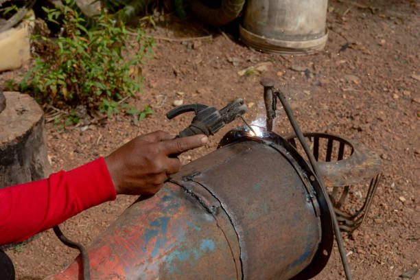 istock Welder is welding metal piping in construction site 1127529130