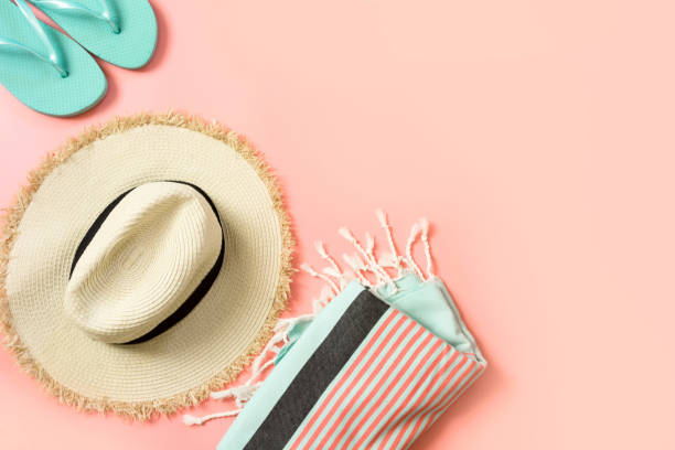 Female outfit for beach. Straw sunhat and beach slaps on punchy pink with space for text. Summer concept. Female outfit for beach. Straw sunhat and beach slaps on punchy pink with space for text. Summer tropical concept. sarong stock pictures, royalty-free photos & images