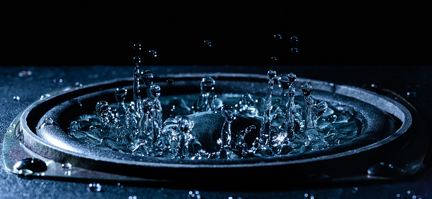 Low angle view of water flowing from shower head in bathroom.