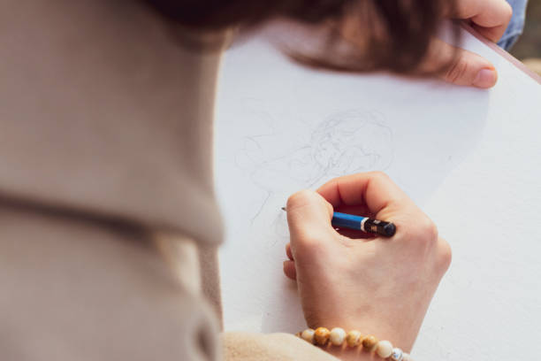 istock Girl drawing with Pencil 1127529997