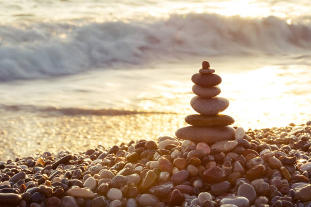 istock Pyramid of sea stones on the beach 1127530073